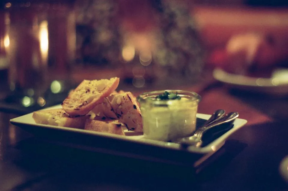 Toasted bread and dips on a wooden board
